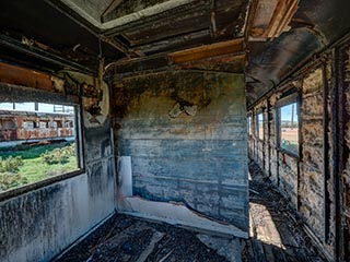 gutted interior of abandoned railway carriage