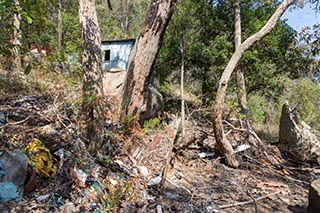 Abandoned house and garbage in the bush near Wondabyne, Australia