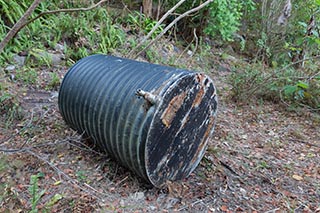 Old water tank lying in the bush near Wondabyne, Australia
