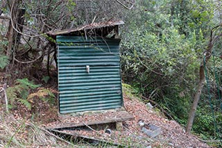 Old corrugated iron shed in the bush near Wondabyne, Australia