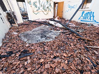 Broken roof tiles on floor of St. John's Orphanage