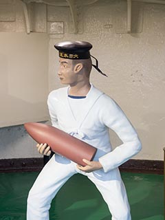 Model of sailor holding 6 inch shell on Battleship Mikasa