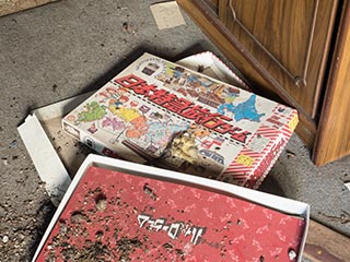 Game box on floor of abandoned house