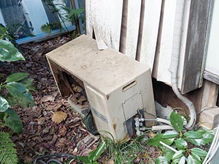 Air conditioner outside abandoned Japanese house