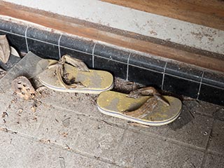 Sandals at entrance to abandoned Japanese house