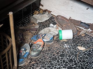 shoes at entrance to abandoned Japanese house