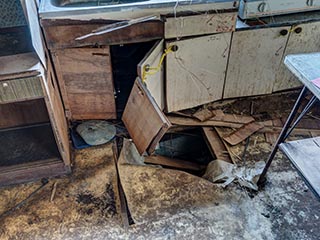 Collapsing kitchen floor in abandoned Japanese house