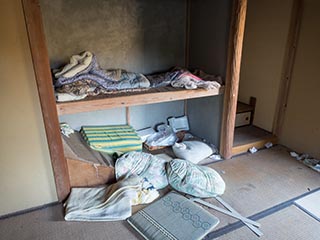 Futons and cushions in abandoned Japanese house