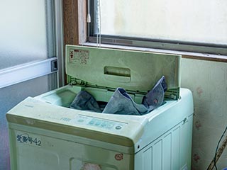 Washing machine in abandoned Japanese house
