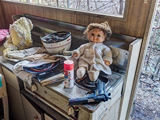 Smith & Wesson handgun and doll in abandoned apartment
