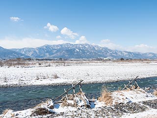 Snowy landscape with river and mountains in Yamanashi Prefecture, Japan