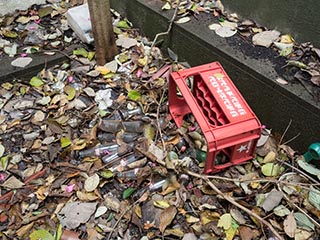Crate of bottles scattered on ground outside Motel Akatsuki