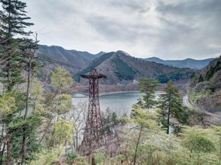 Abandoned Kawano Ropeway tower above Lake Okutama