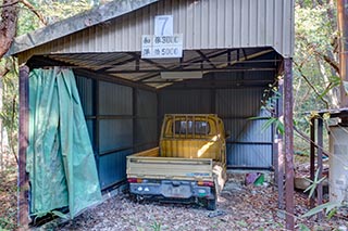 Old truck in carport of abandoned love hotel Century