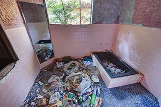 Garbage strewn bathroom in abandoned love hotel Century