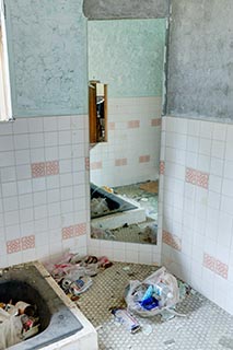 Garbage strewn bathroom in abandoned love hotel Century
