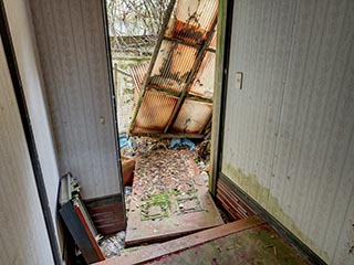 Collapsed guest room door in Motel Sun River