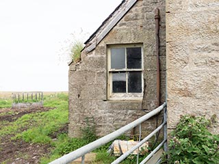 kitchen window of abandoned house