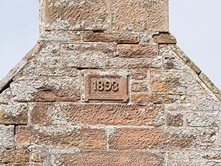 1893 carved in storehouse wall