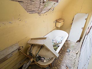cramped bathroom in abandoned house