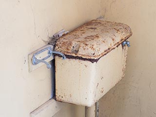 rusty old toilet cistern