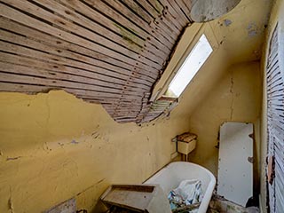 cramped bathroom in abandoned house