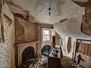 decaying upstairs bedroom in abandoned house