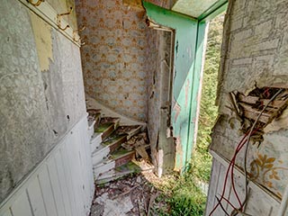foot of stairs in abandoned house