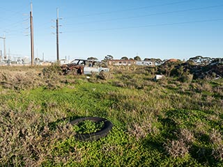 old tyre, abandoned Ford Falcon, abandoned railway carriages