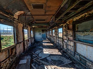 gutted interior of abandoned railway carriage