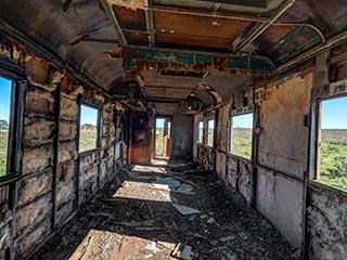 gutted interior of abandoned railway carriage