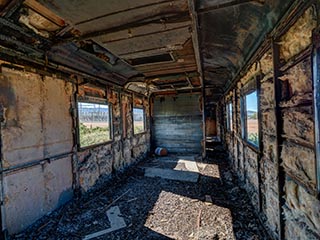 gutted interior of abandoned railway carriage