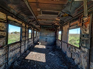 gutted interior of abandoned railway carriage