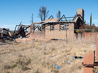 Hills Hoist and burnt-out building