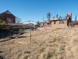 Hills Hoist and burnt-out building