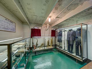 Display of uniforms and musical instruments aboard Battleship Mikasa