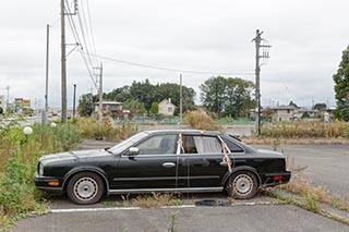 Abandoned Car in front of Burnt Out Wedding Venue