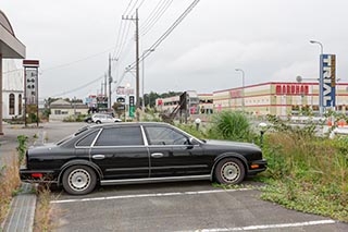 Abandoned Car in front of Burnt Out Wedding Venue