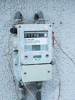 Gas meter outside abandoned Japanese house