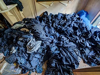 Abandoned house full of school uniforms