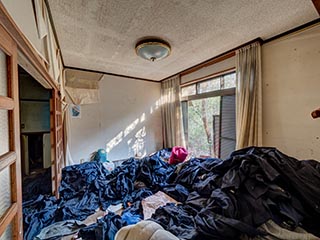 Abandoned house full of school uniforms