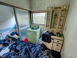 Abandoned house full of school uniforms