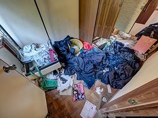 Abandoned house full of school uniforms