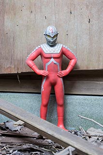 Action figure outside abandoned Japanese house