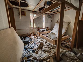 Garbage filled guest room in Hotel Bluebird