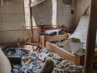 Garbage filled guest room in Hotel Bluebird