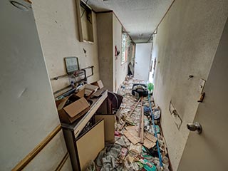 Garbage filled corridor in Hotel Bluebird