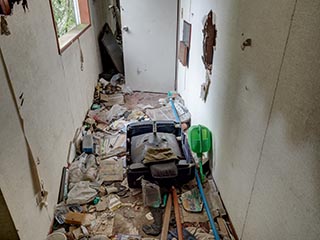 Garbage filled corridor in Hotel Bluebird