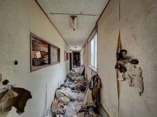 Garbage filled corridor in Hotel Bluebird