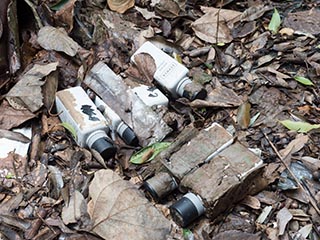 Old shampoo bottles lying on ground